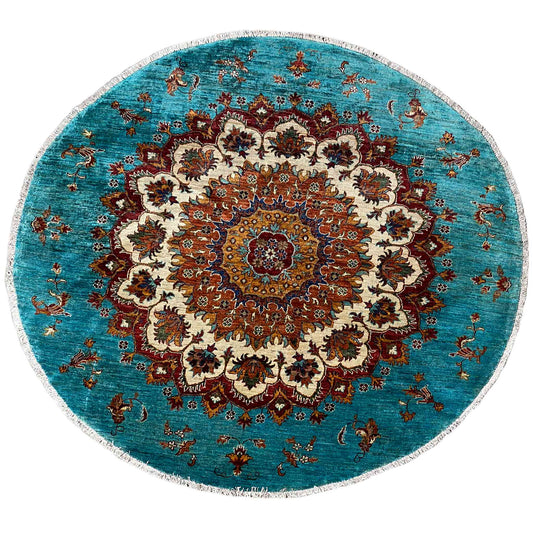 Round turquoise Khorjin rug with an ornate central medallion and multicolored pattern.