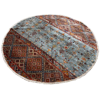 Round wool rug, hand-knotted, gray-blue with a geometric pattern in brown and orange