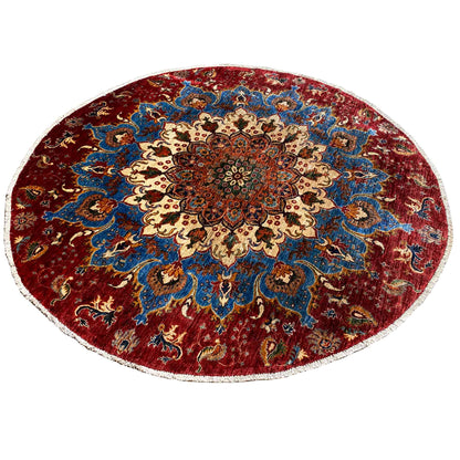 Round wool rug with a centered medallion and red and blue pattern