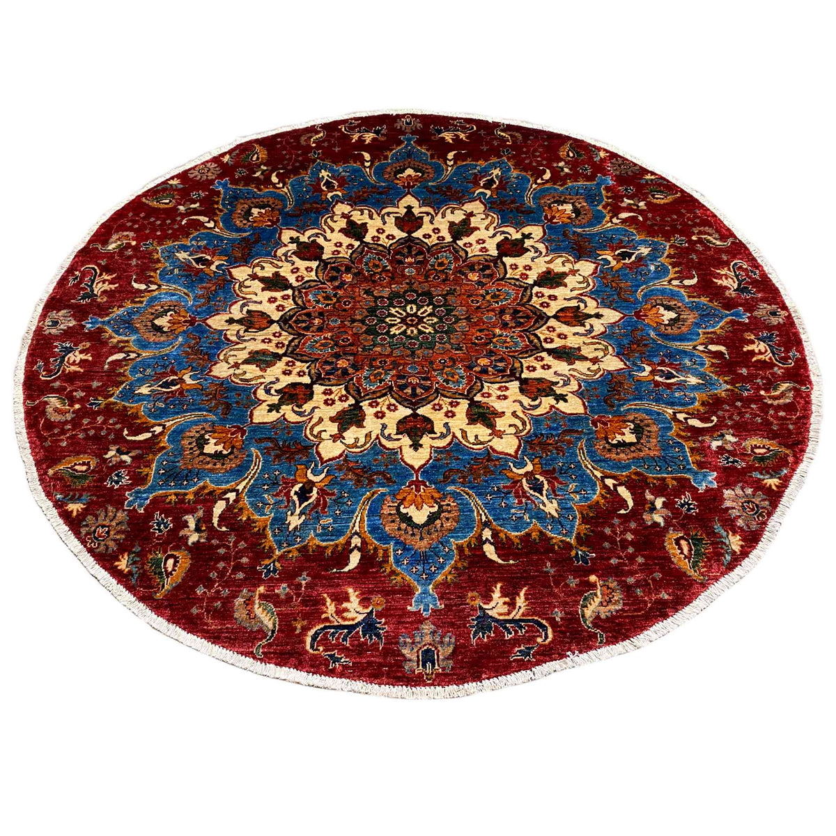 Round wool rug with a medallion in the center, red and blue pattern with motifs at the bottom