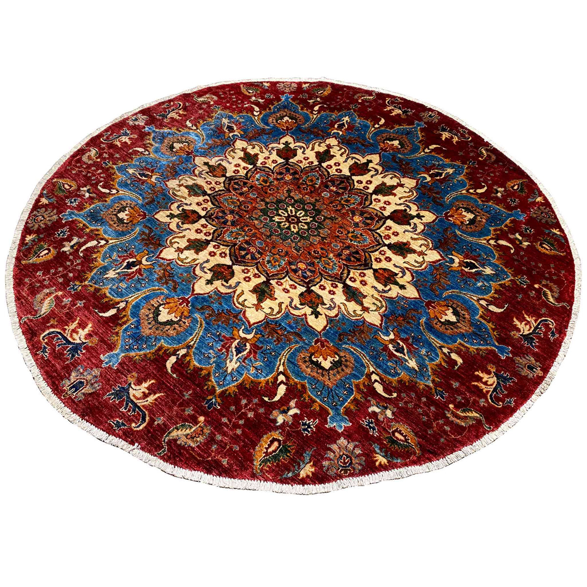 Round wool rug with a red background, blue vine pattern, and central medallion flower