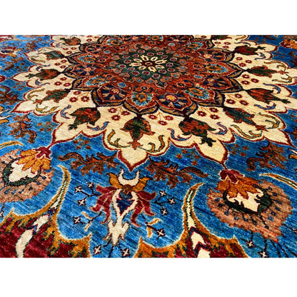 Close-up of the wool rug: red and blue ornamental pattern with cream-colored vines