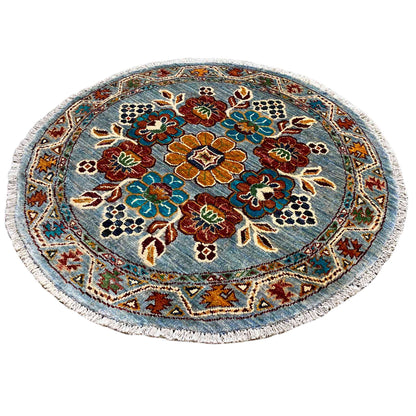 Khorjin round wool rug with a blue background and colorful flowers, central medallion frame