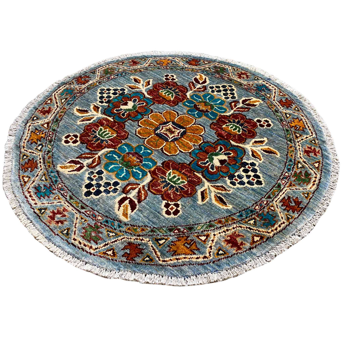 Khorjin round wool rug: bold floral pattern in blue, red, and green with border
