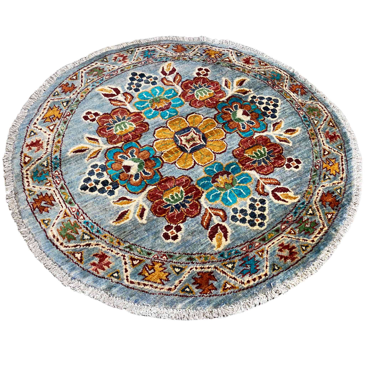 Khorjin round wool rug: dense floral and vine pattern in red, green, and blue