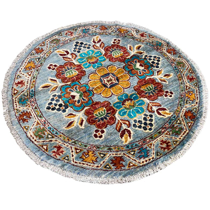 Khorjin round wool rug: dense floral and vine pattern in red, green, and blue