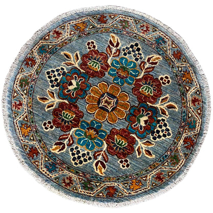 Round khorjin wool rug: blue floral pattern with colorful ornaments and decorative border
