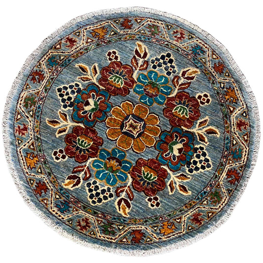 Round khorjin wool rug: blue floral pattern with colorful ornaments and decorative border