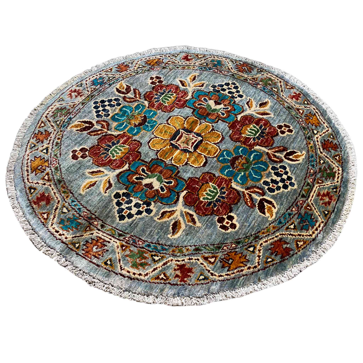 Round wool rug with a blue floral pattern and geometric border