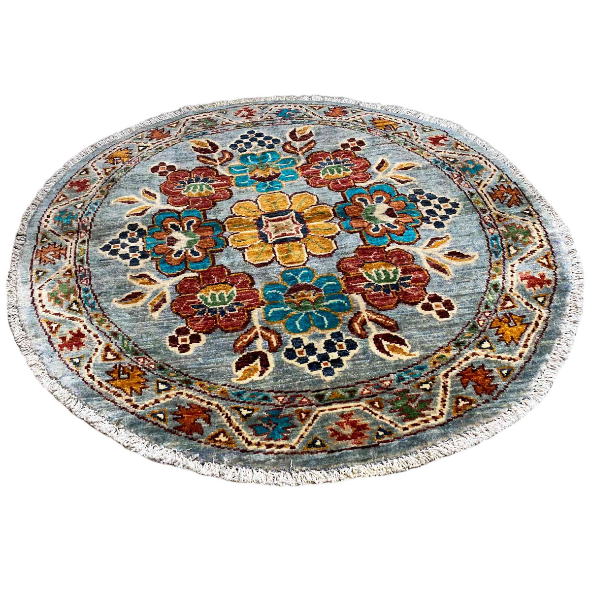 Round wool rug with a blue background and colorful floral ornaments