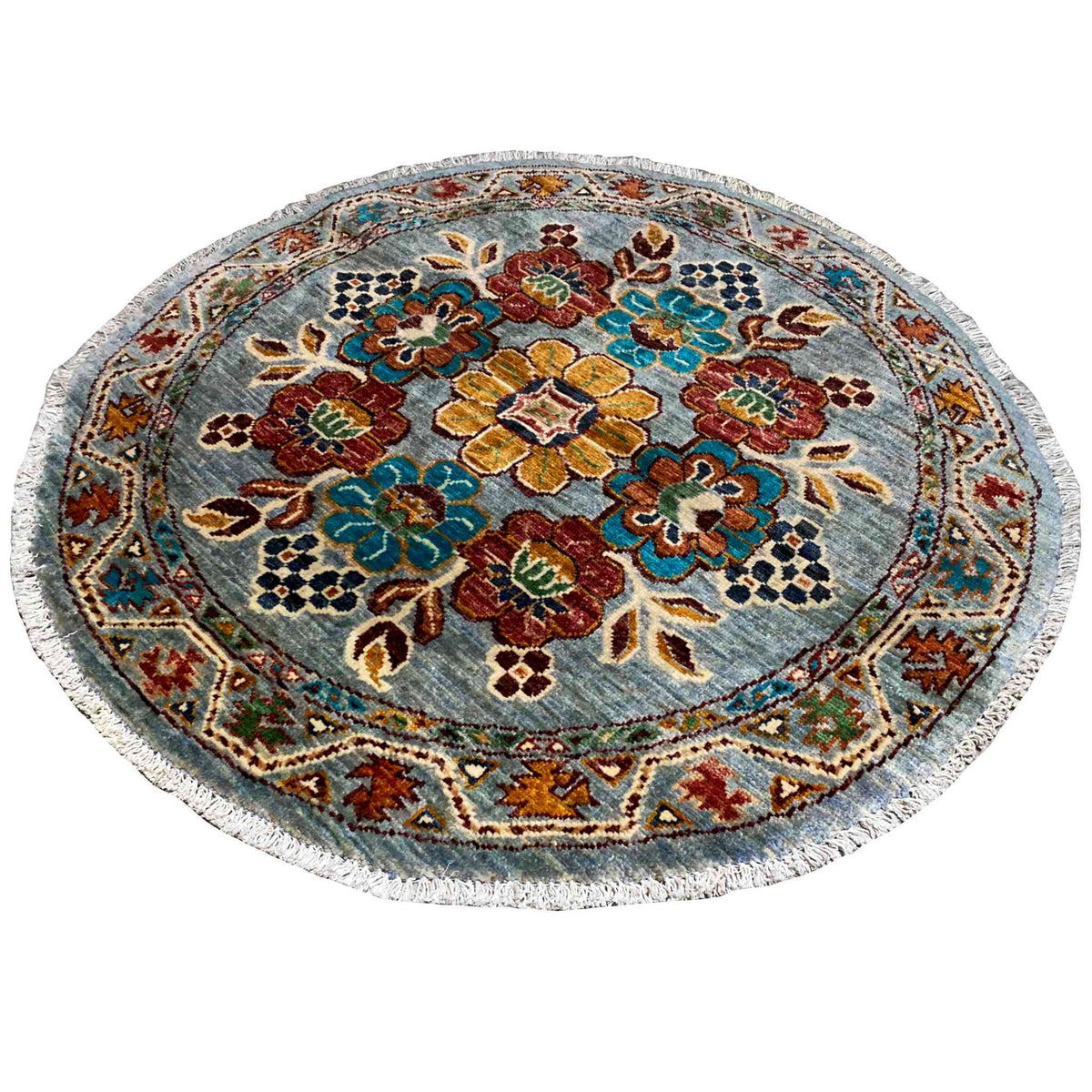 Round wool rug with a blue floral pattern and a densely patterned border
