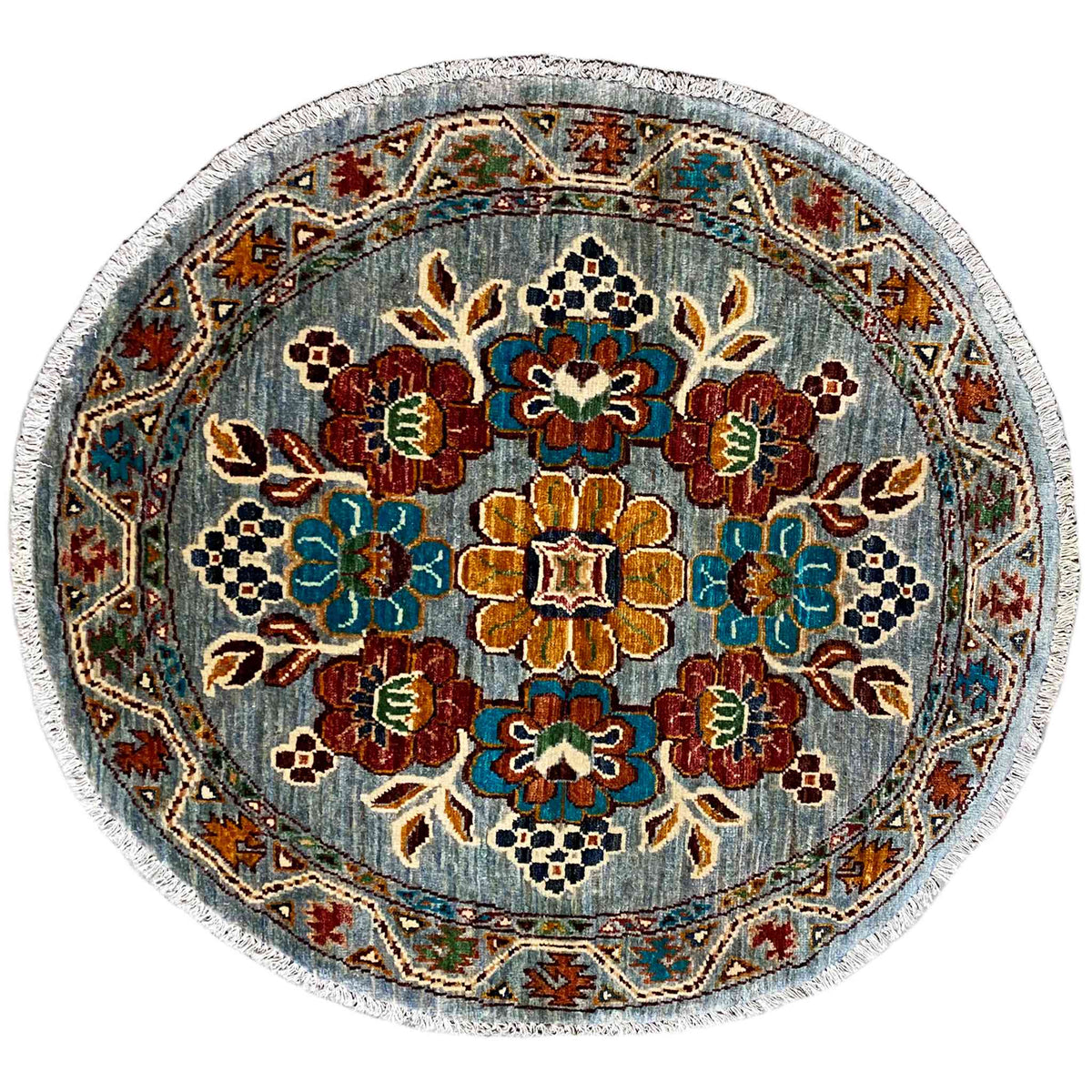Round wool rug with a blue floral pattern and multicolored edging