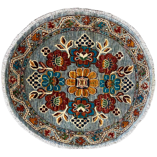 Round wool rug with a blue floral pattern and multicolored edging