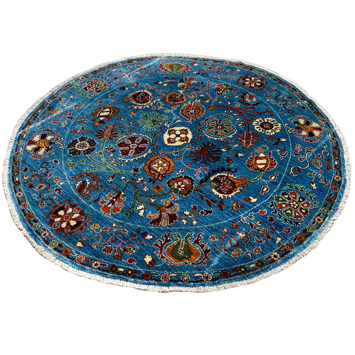 Blue round wool rug with a dense vintage-style floral and animal ornament pattern