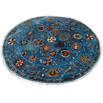 Blue round wool rug with a dense vintage-style floral and animal ornament pattern