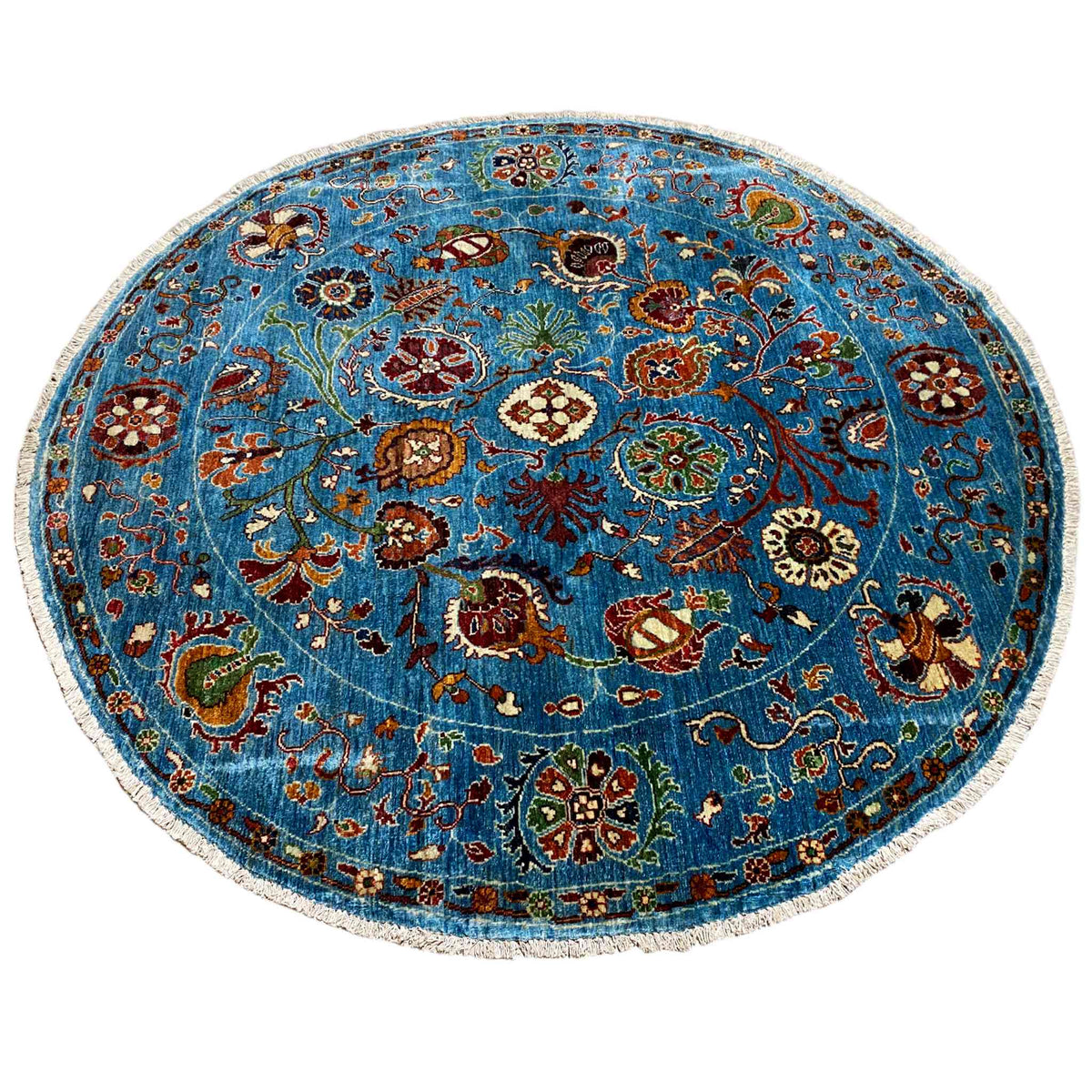 Round blue wool rug with a vibrant floral pattern and intricately detailed border