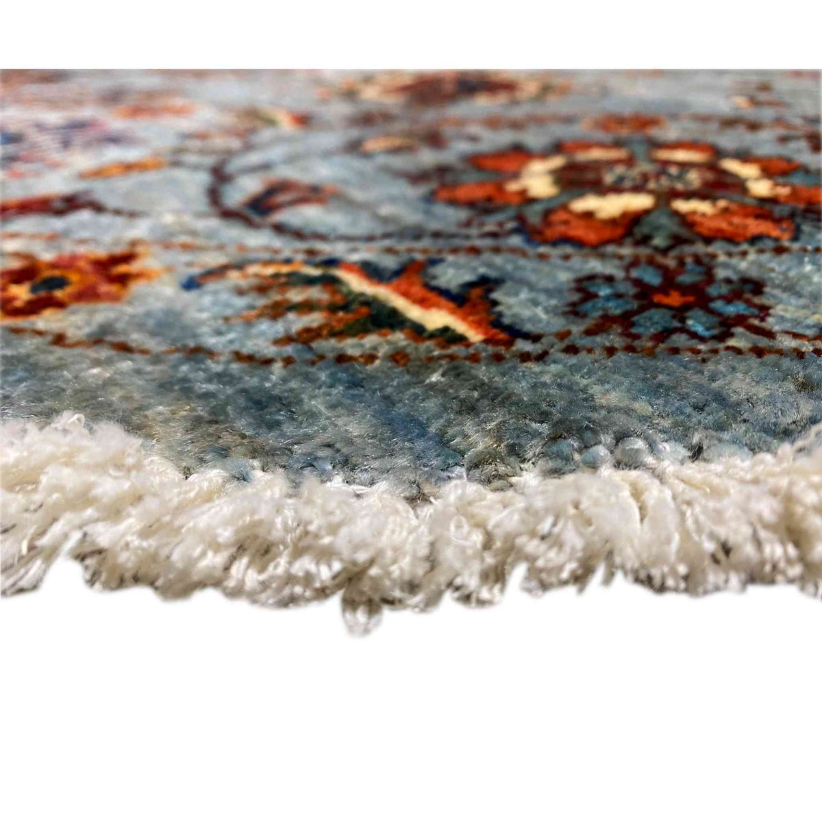 Hand-knotted Khorjin rug edge view with beige fringe trim