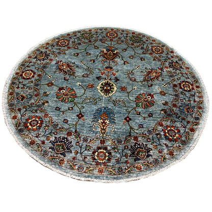 Round Khorjin wool rug, light blue-gray, with a colorful floral decorative pattern
