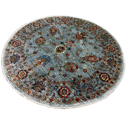 Round Khorjin wool rug in light blue-gray with an intricate animal and floral pattern