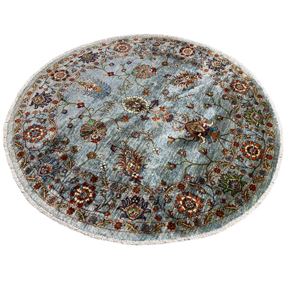 Round Khorjin wool rug in light blue-gray with medallion and floral ornaments