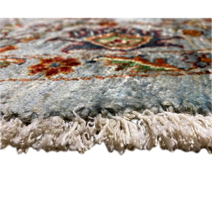 Khorjin wool rug with a light wool fringe finish and light blue-gray pile