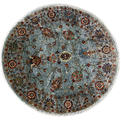 Round Khorjin wool rug in light blue-gray with a colorful floral ornamental pattern