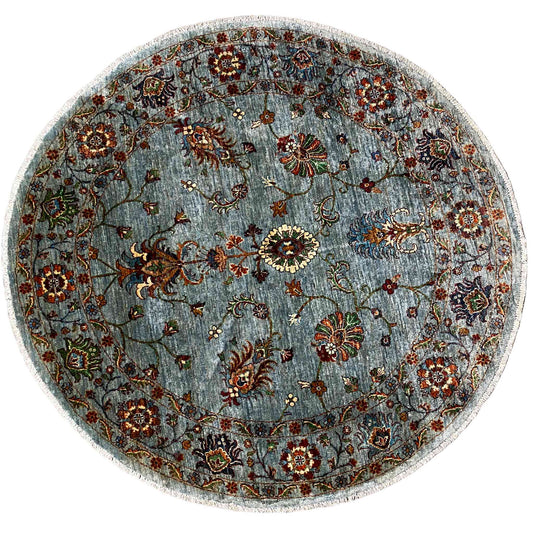 Round Khorjin wool rug in light blue-gray with a colorful floral ornamental pattern