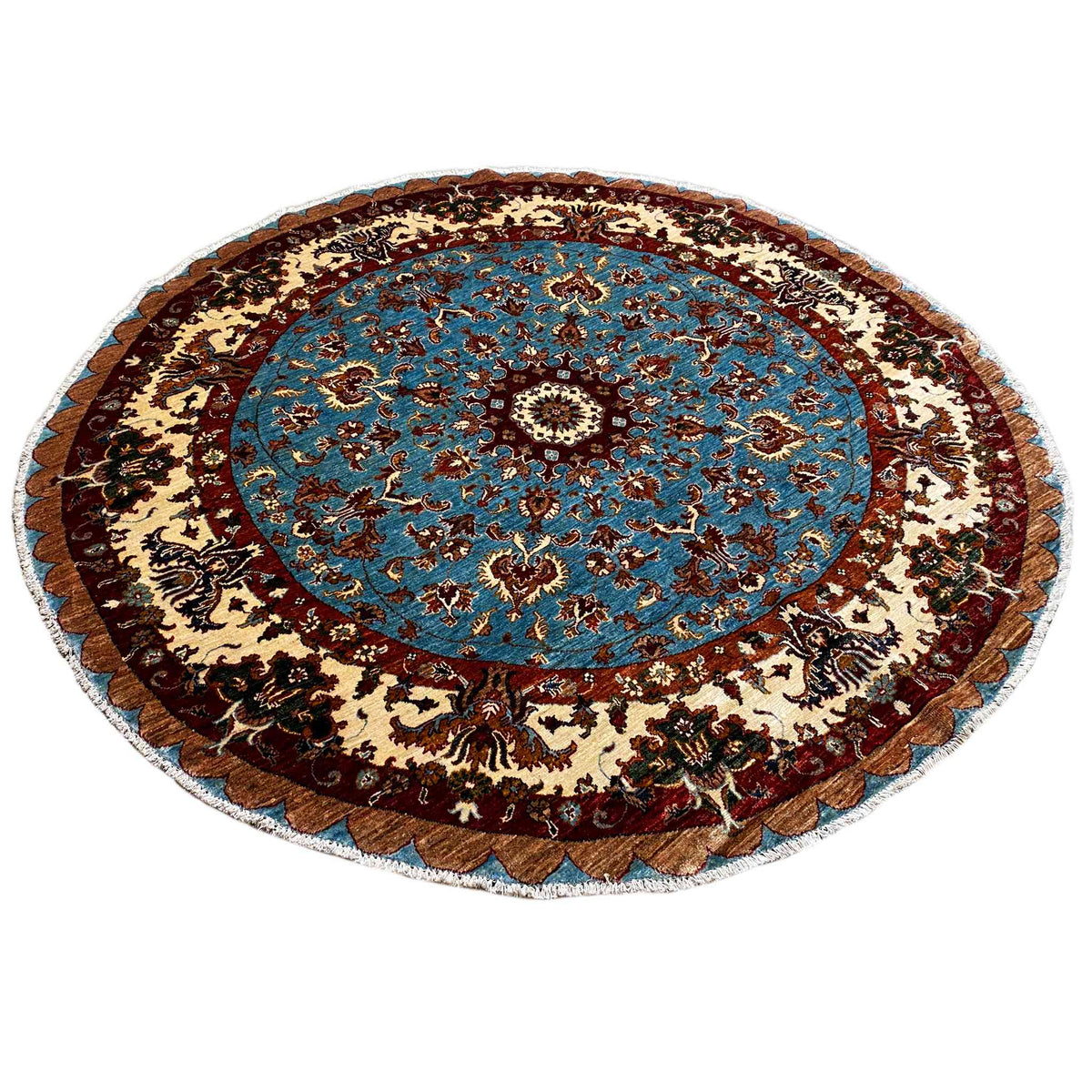 Round wool rug with a blue central medallion and a wide decorative border in brown and beige