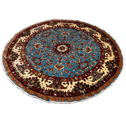 Round wool rug with a blue medallion, border, and baroque ornaments in brown