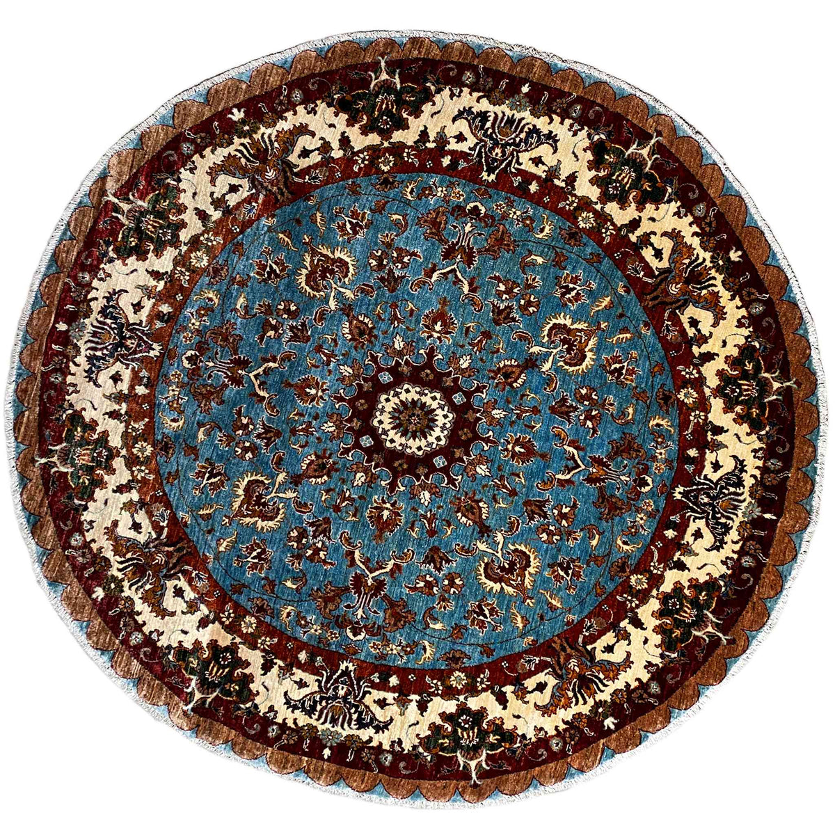 Round woven wool rug with a blue medallion and beige and brown ornaments