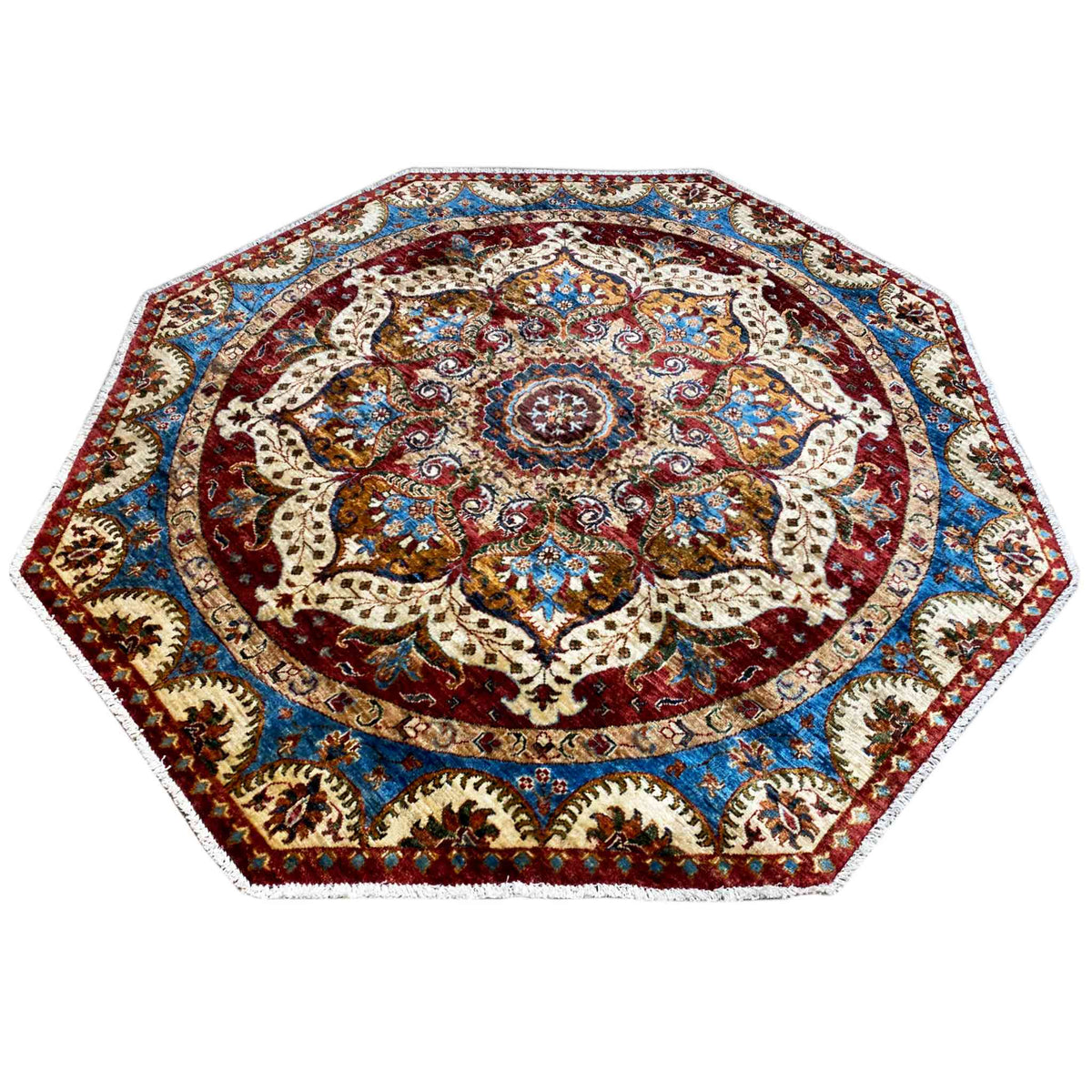 Octagonal rug with a symmetrical ornamental border in red, blue and cream