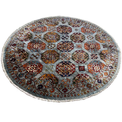 Round rug: geometric hexagon patterns in orange, red, and blue on a light gray background