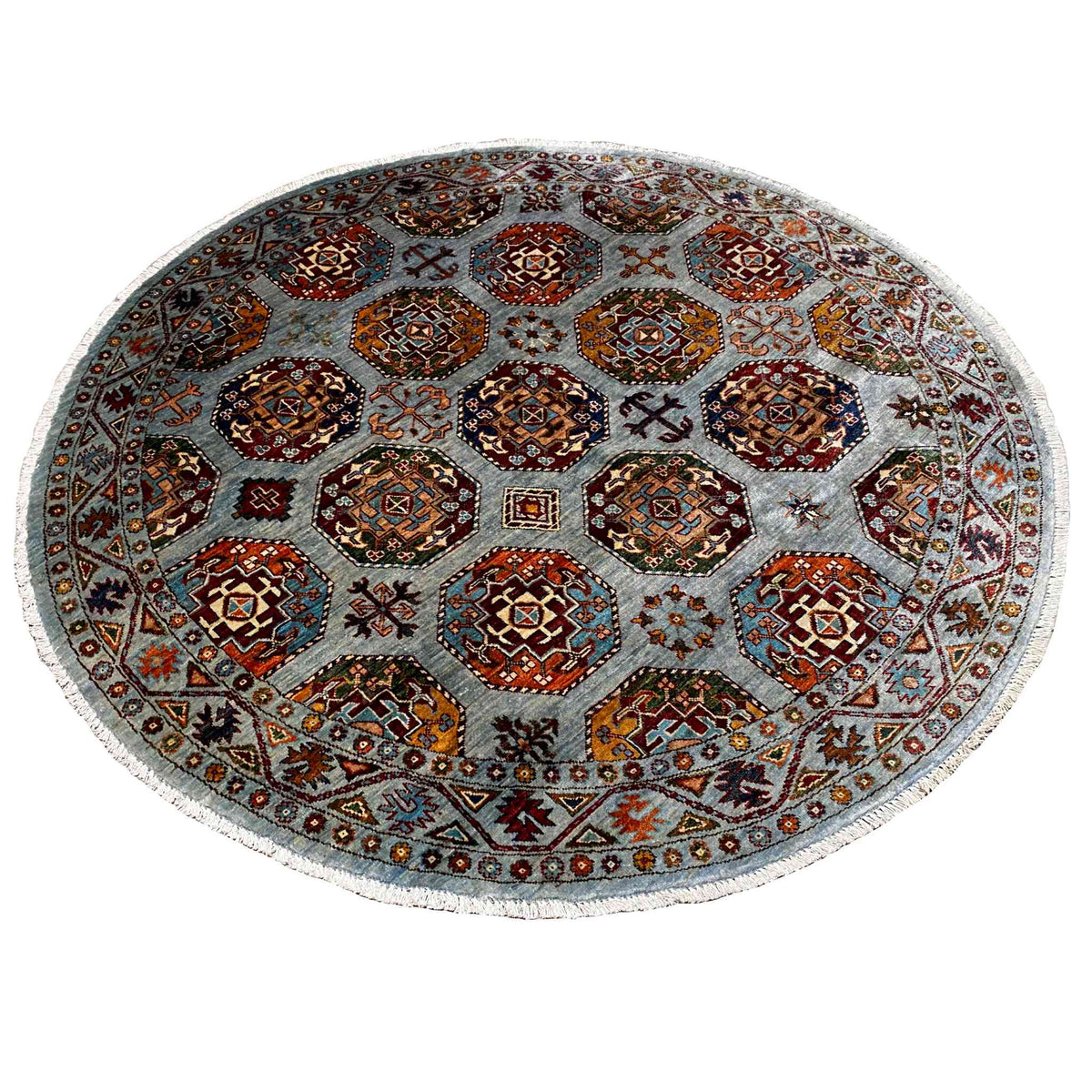 Round rug with a dense pattern of squares and crosses, multicolored on a light background