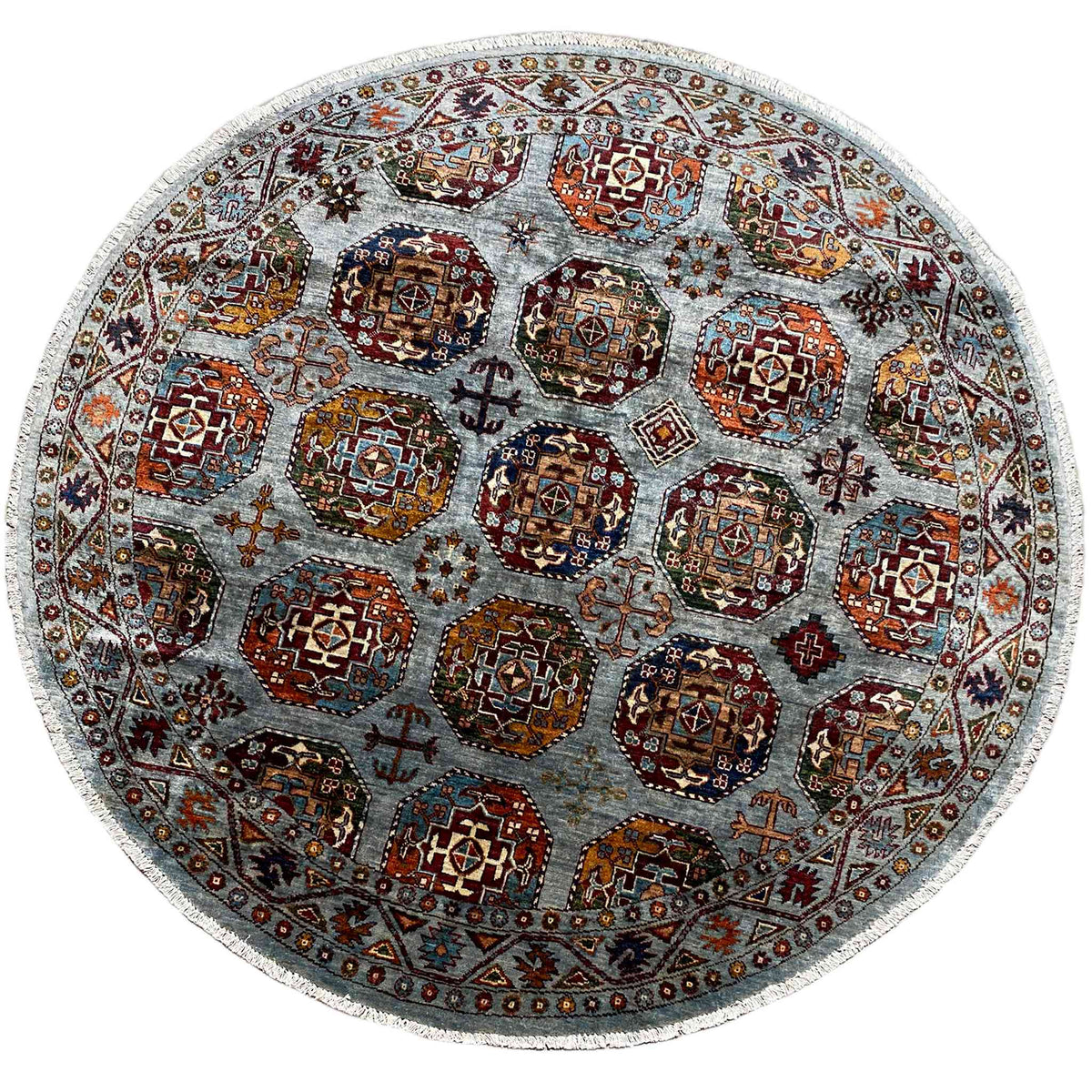 Round rug with a multicolored ornamental pattern on a light gray-blue background