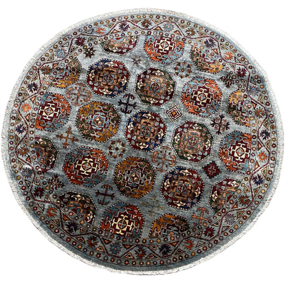 Round rug with a multicolored ornamental pattern on a light gray-blue background