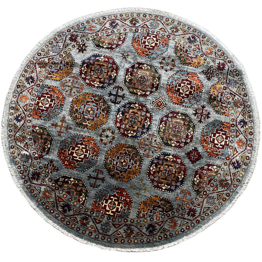 Round rug with a multicolored ornamental pattern on a light gray-blue background
