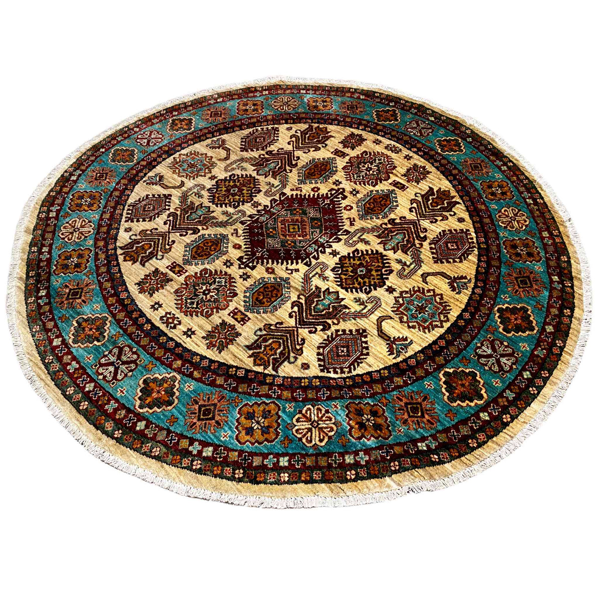 Round rug with a geometric design, a turquoise-brown border, and a cream center