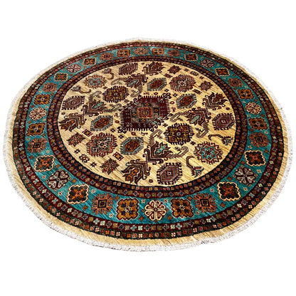 Round rug with a geometric design, a turquoise-brown border, and a cream center