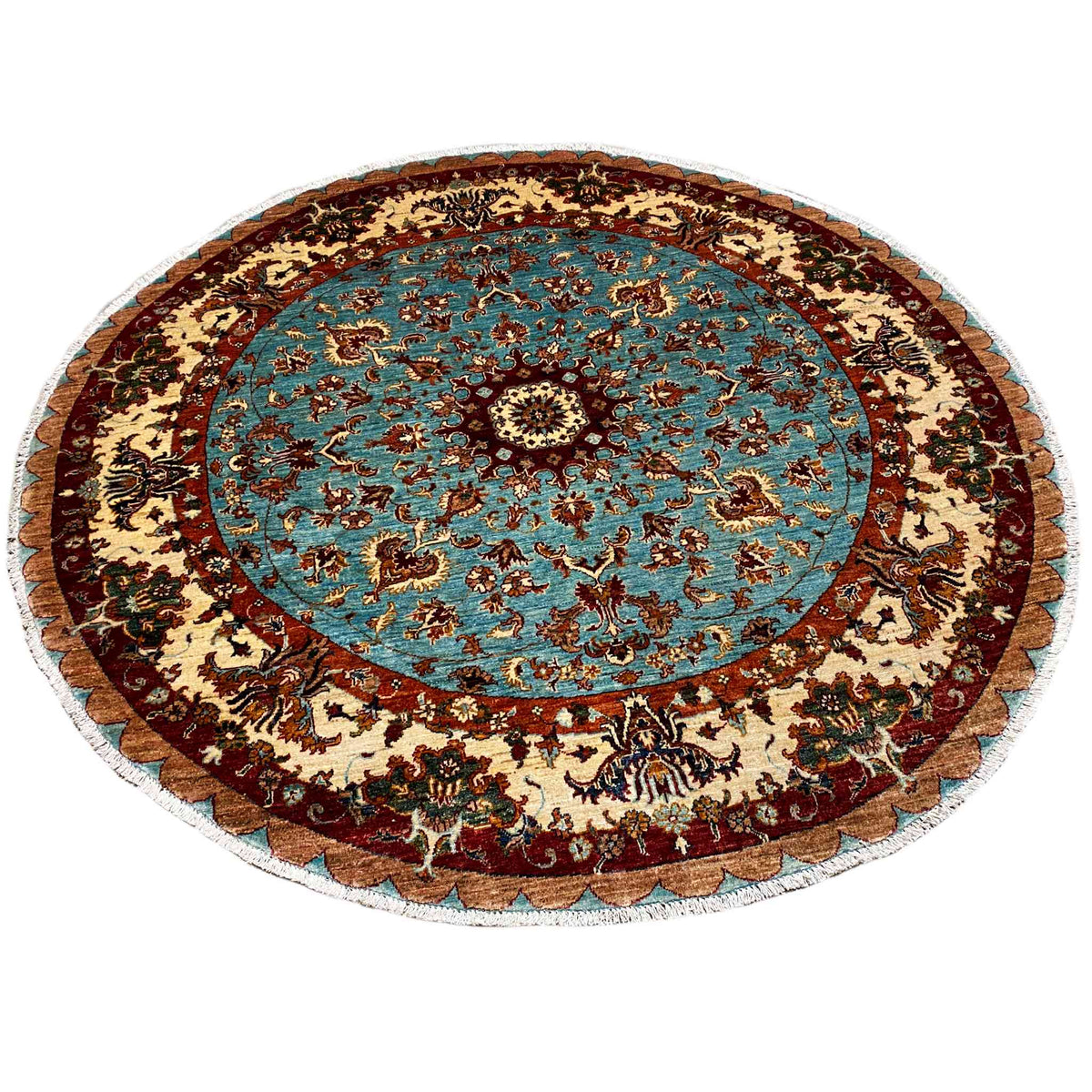 Round wool rug with a blue patterned field, floral ornaments, and a decorative border
