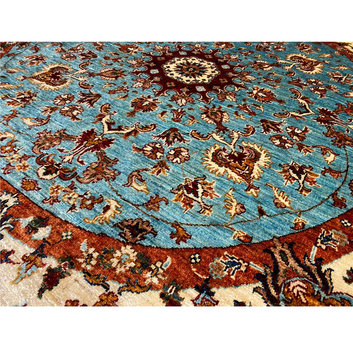 Detail view: blue ornamental pattern with brown decorative elements on a textile surface