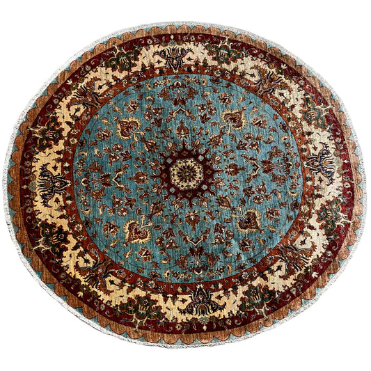 Round wool rug with a blue medallion and baroque ornamental pattern, border with a tassel look