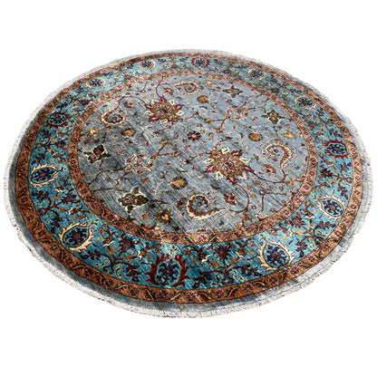 Round rug with a gray-blue background, red and gold ornaments, and a turquoise border