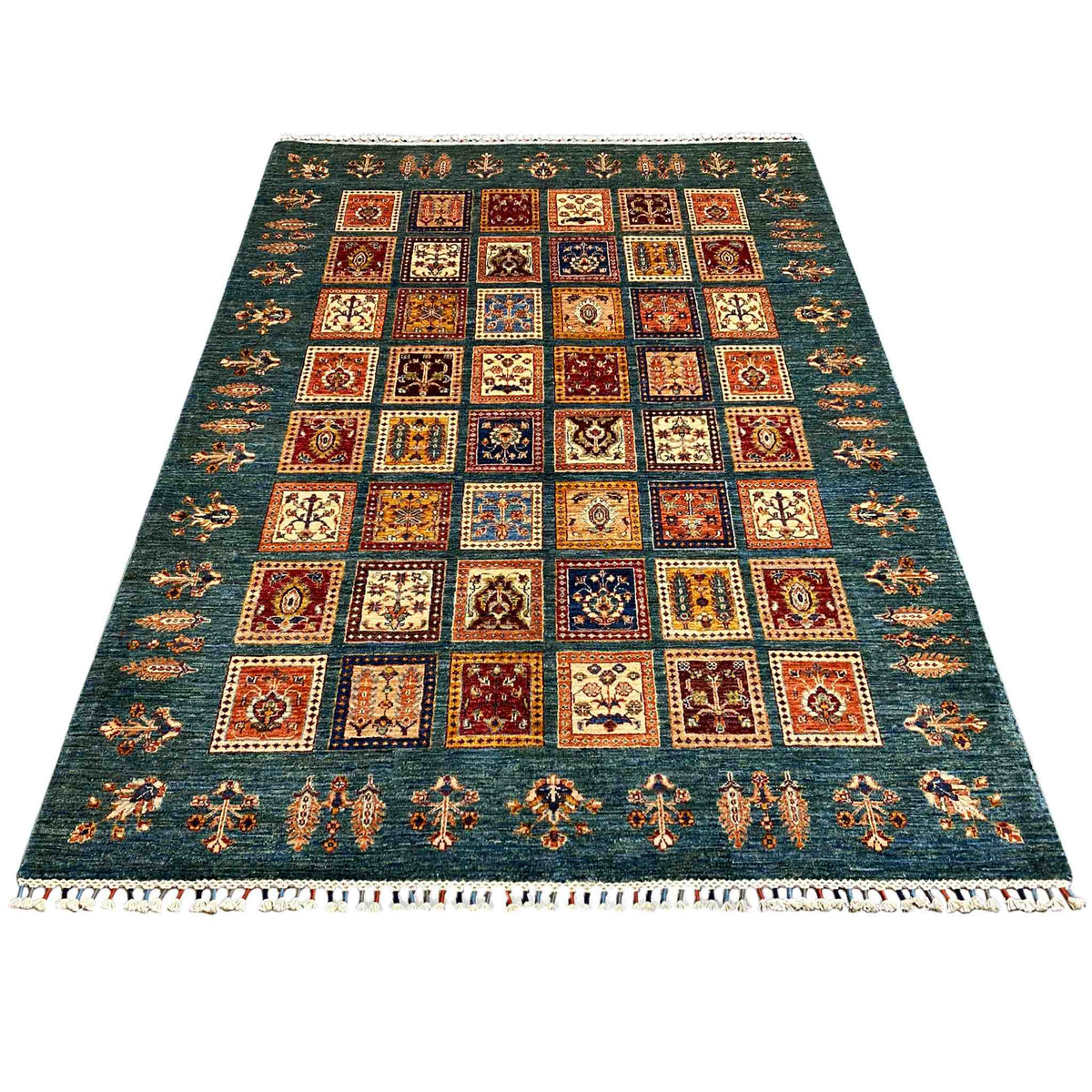 Blue-green rug with multicolored square patterns and a white fringed border