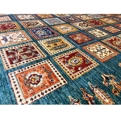 Blue-green rug with square-pattern details, multicolored decorative ornaments, woven border