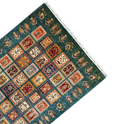 Teal-blue carpet with a square pattern and decorative side border, multicolored details, fringes