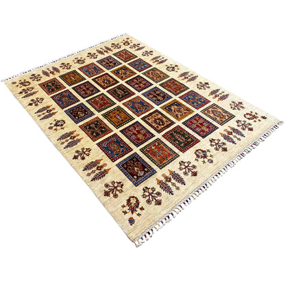 Rug in angled view: cream-colored surface with multicolored square motifs and fringes