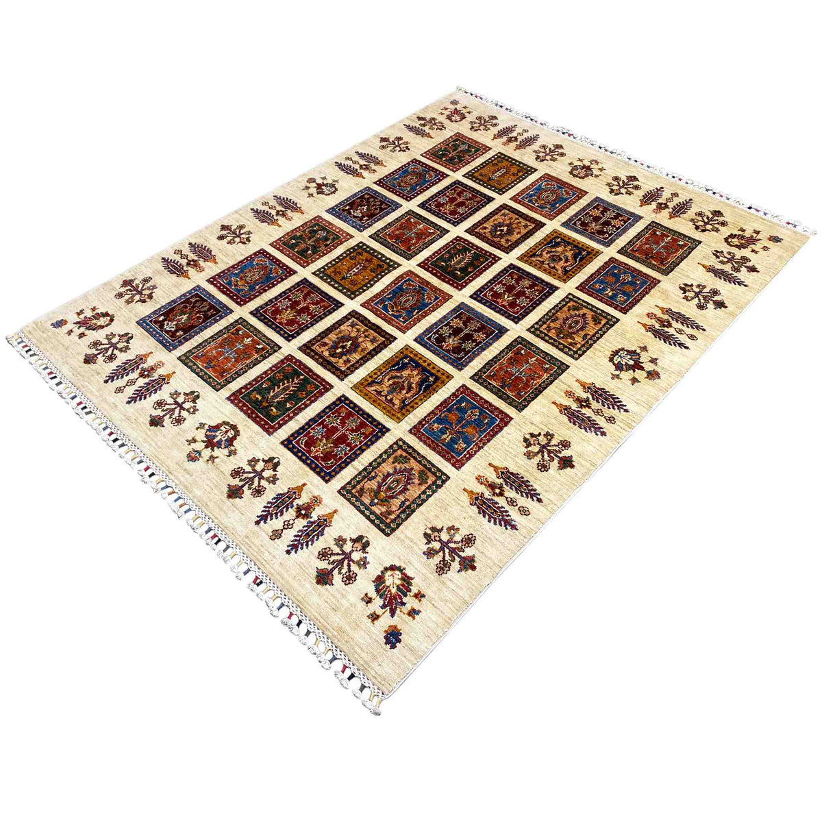 Rug at an angle: colorful square motifs on a cream-colored background, fringes all around