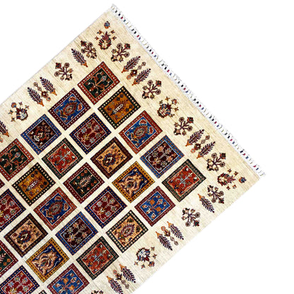Carpet corner with decorative border, cream-colored background, and colorful square patterns