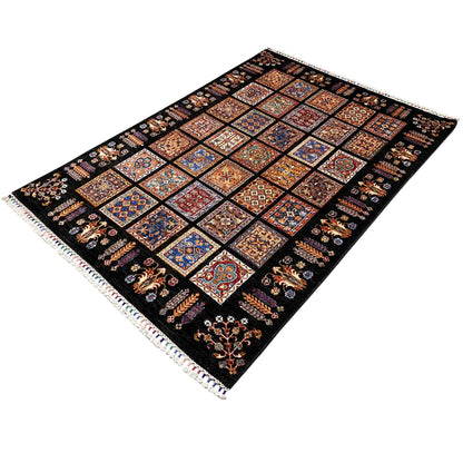 Rug with colorful ornamental tiles in a grid on a black background, with fringes