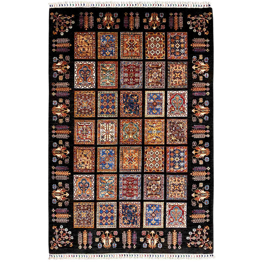 Traditional wool rug with a black background and colorful tile patterns, with a fringed edge